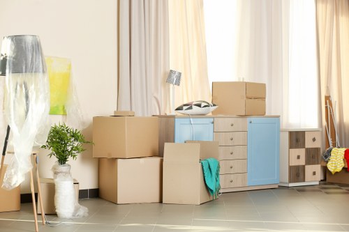 Local office removals team handling packed business equipment in Hammersmith