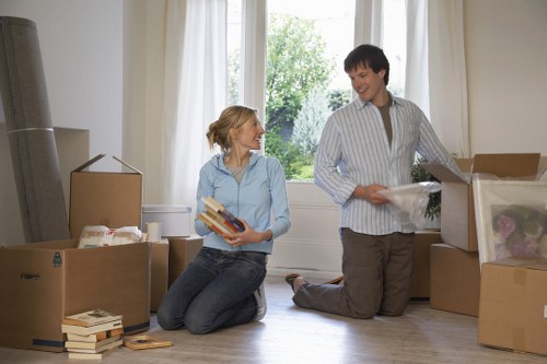 Mover carrying wrapped household items with care during relocation