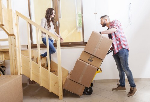Professional movers handling furniture for a same day move in a Hammersmith flat