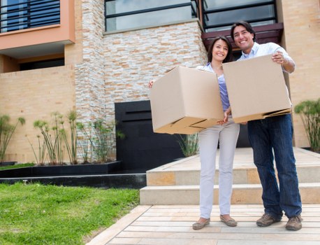 Professional movers carrying items from a flat in Hammersmith during moving day