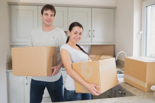 Packed moving boxes and furniture ready for transport in West London